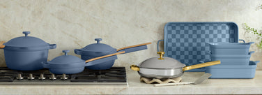 Set of blue cookware on a kitchen counter with a neutral background