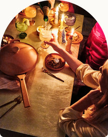 serving food and drinks on table with always pan and party coupes