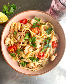 creamy prawn fettuccine in a pink bowl