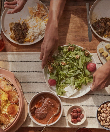 our place dinnerware and cookware assortment serving food on table