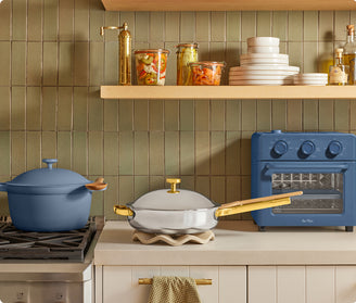 Kitchen scene with cookware, oven, and shelves against a tiled wall.