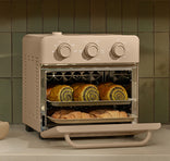 Beige toaster oven with baked goods on a kitchen counter