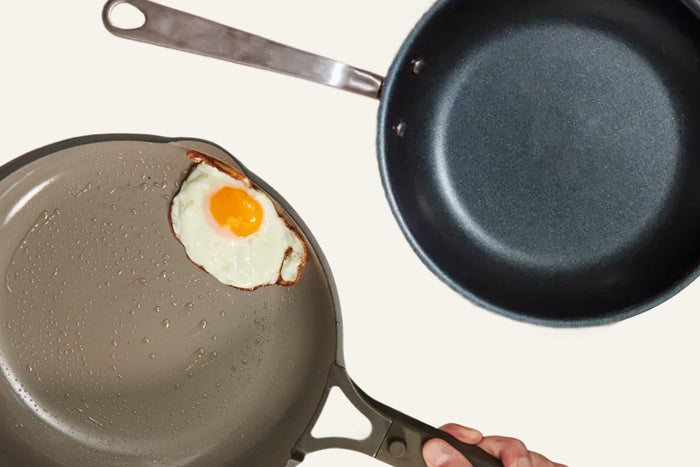 Two pans with an egg inside one of them 