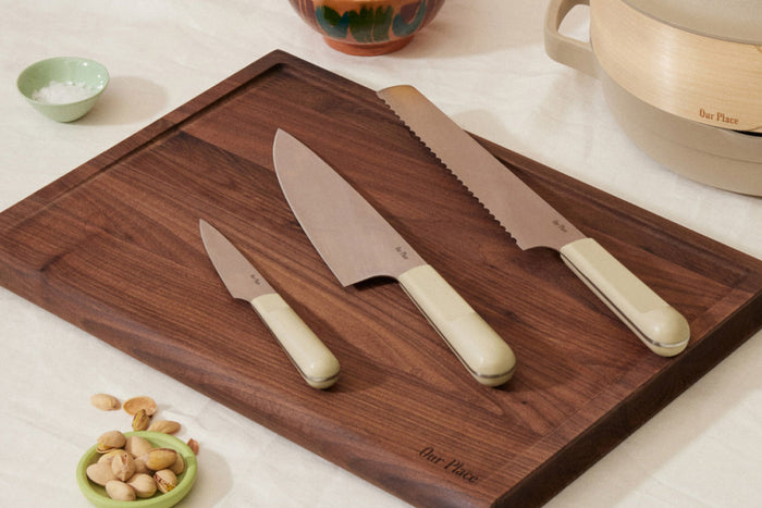 Three knives on a cutting board