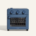 Blue toaster oven with diamond pattern on a white background