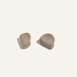 Pair of beige silicone pot holders  on a light beige background