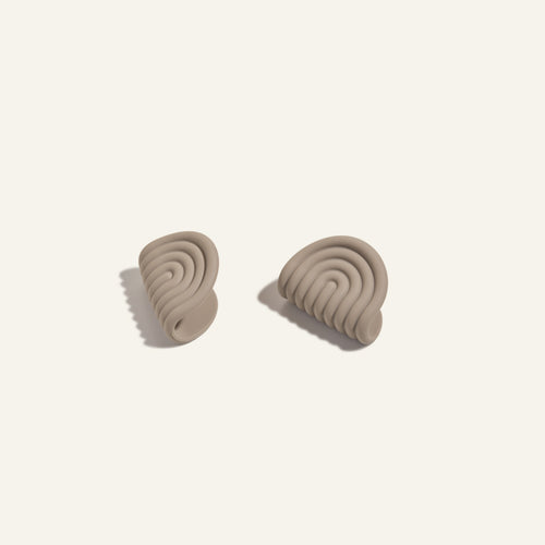 Pair of beige silicone pot holders  on a light beige background