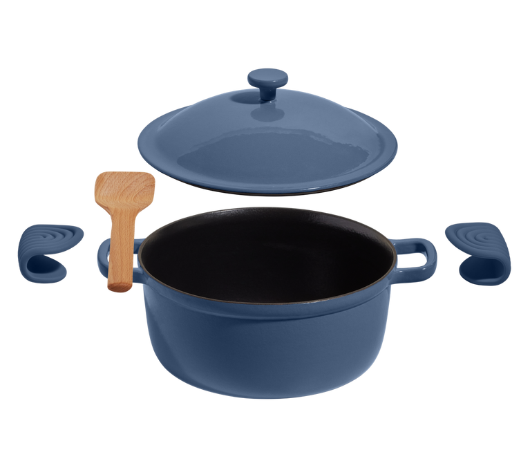 A blue Dutch oven with a matching lid, a pair of silicone handle covers, and a wooden spatula arranged on a white background.