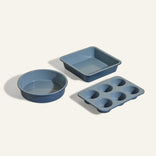 The Wonder Oven Baker's Kit features three non-toxic bakeware pieces—a round cake pan, a square baking pan, and a six-cup muffin tin—perfectly sized for your Wonder Oven and displayed on a light background.