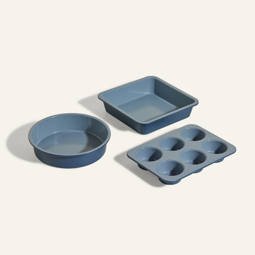 The Wonder Oven Baker's Kit features three non-toxic bakeware pieces—a round cake pan, a square baking pan, and a six-cup muffin tin—perfectly sized for your Wonder Oven and displayed on a light background.
