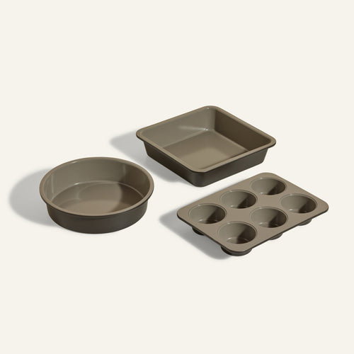 The Wonder Oven Baker's Kit features three non-toxic taupe pans—a round, a square, and a six-cup muffin tray—perfectly designed for your Wonder Oven and arranged beautifully on a white background.