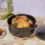 black cast iron perfect pot with roasted chicken