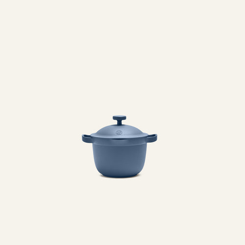 The Petite Perfect Pot, a compact blue nonstick pot with dual handles, sits centered on a plain light background—ideal for single servings.