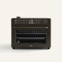Wonder Oven Pro, a countertop convection mini oven with air fryer function, digital display, control buttons, and multiple racks is shown against a plain light background.