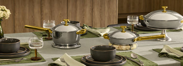 Set of cookware on a table with a neutral background