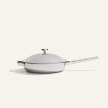 Titanium Always Pan Pro 26 cm (2.0) wide-rimmed stainless steel frying pan with a matching lid and a long metal handle.