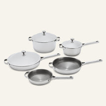 A Titanium Pro Cookware Set+ consisting of five stainless steel pieces, including three pans with matching lids and two open skillets.