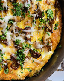 Close-up of a pizza with mushrooms and cheese on a pan