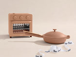Miniature oven and frying pan set on a beige background with 'Our Place' branding.