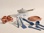 Set of kitchen utensils and cookware on a beige background