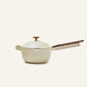 The Ceramic Nonstick Perfect Pot 2.5 L is a beige pot with a nonstick surface, featuring a lid with a wooden knob and a long handle accented with wood. Designed for safe, non-toxic cooking, this multifunctional pot brings versatility to your kitchen.